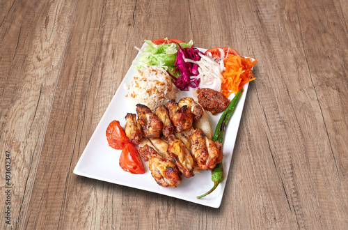 Chicken drumsticks  and vegetables on wooden table