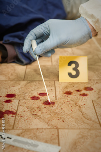 Crime scene investigation - collecting of blood samples for laboratory photo