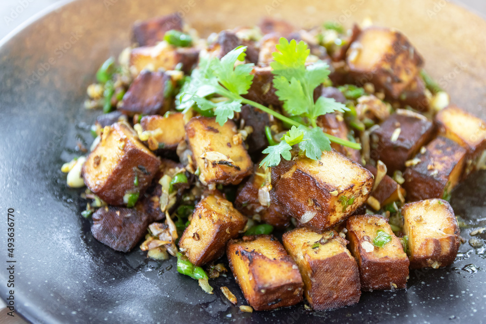 Stir-fried black tofu with chili, salt, garlic and pepper. Authentic the rare black tofu found only in Ratchaburi, Photharam Village, Thailand. Balance salty and sweet stew with sweet herbal gravy. Stir-fried black tofu with chili, salt, garlic and pepper. Authentic the rare black tofu found only in Ratchaburi, Photharam Village, Thailand. Balance salty and sweet stew with sweet herbal gravy.