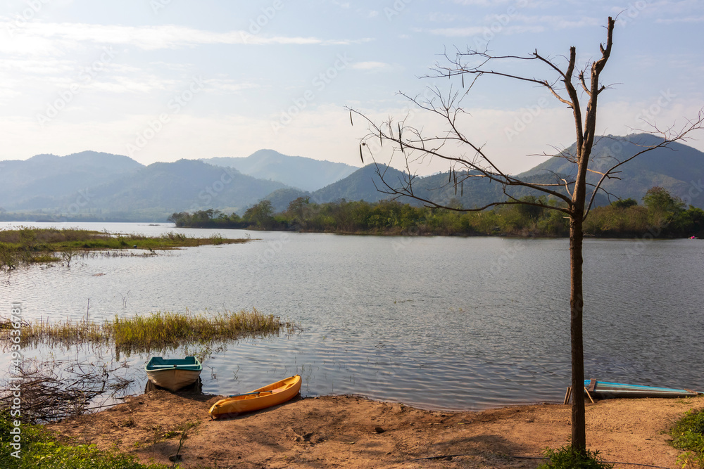 Tha Khoei reservoir in Ratchaburi, Thailand. Beautiful landscape of lake and range of mountain with pine forest. 