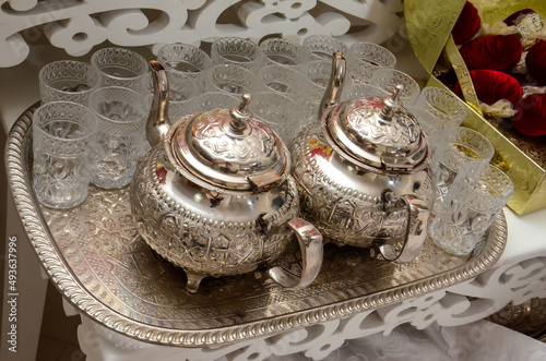 Traditional Moroccan tea set with bronze platter and glasses. photo