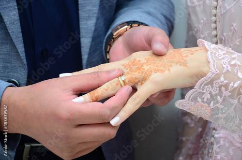 An Arab groom wears his bride s wedding ring