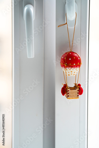 toy wooden red retro balloon hanging on the window handle