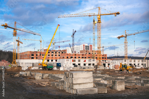 Process of building a house with cranes. New Property. business investment. Constructions background