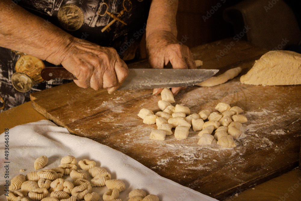 hands kneading gnocchi, Woman working with dough