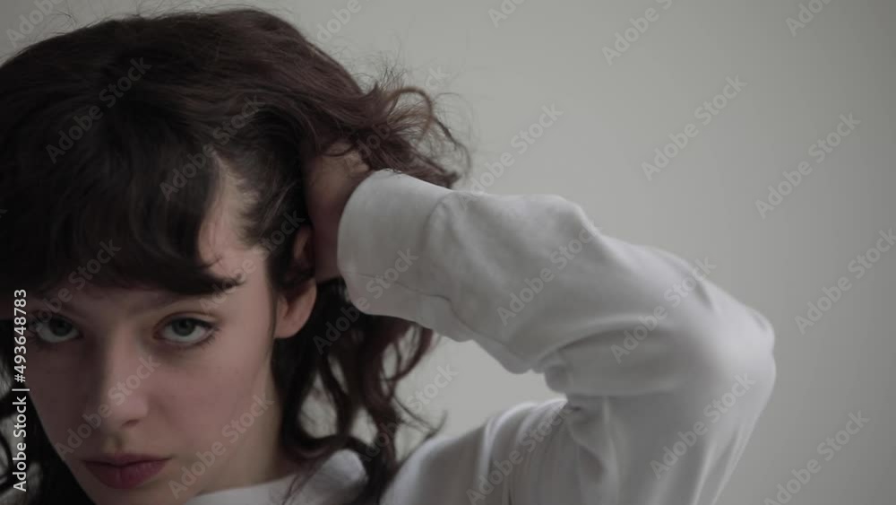 Slow motion portrait of a young woman with curly hair. Slow motion portrait of a young woman with curly hair.