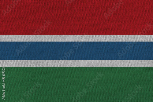 Patriotic textile background in colors of national flag. Gambia © Julia