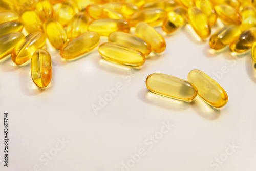 Group of pills of Omega 3 on white background. Healthcare concept. Copy space for text. Top view. Close up. Fish oil food supplement oil-filled capsules suitable. Saturated Fat, Healthy Acid Capsules.