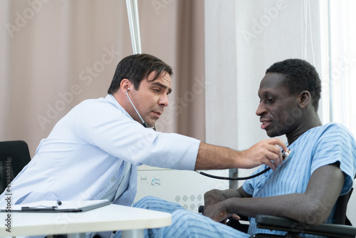A hospital doctor is examining the symptoms of an inpatient