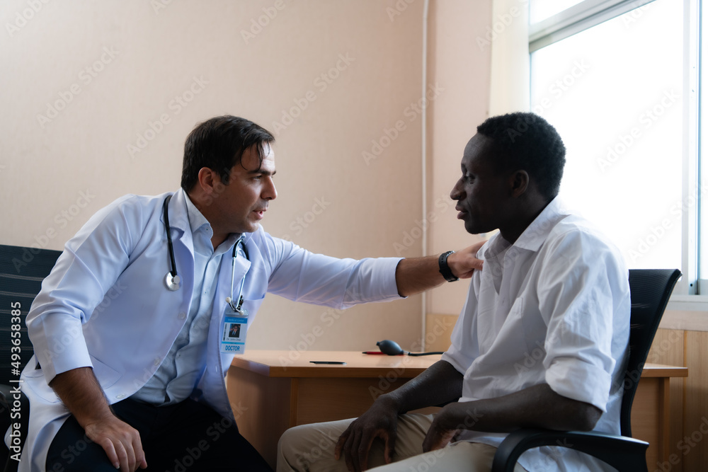 A hospital doctor is examining the symptoms of an inpatient A hospital doctor is examining the symptoms of an inpatient