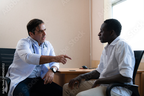 A hospital doctor is examining the symptoms of an inpatient