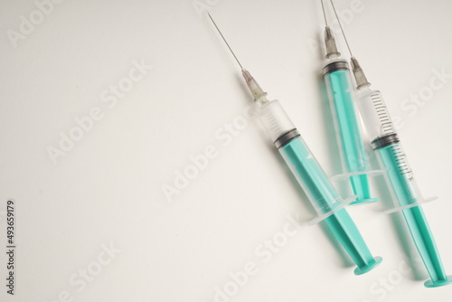 medical disposable syringe with needle for injection in the hospital. medical devices on a white background. virus protection concept