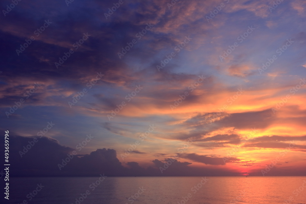 Morning sunrise from the sea in gray clouds Morning sunrise from the sea in gray clouds