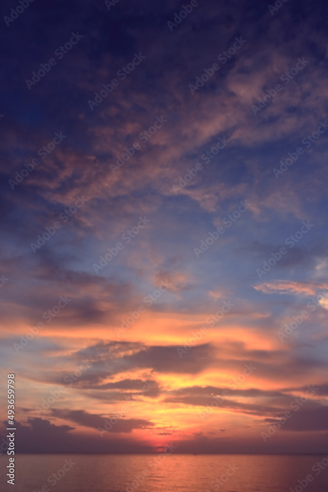 Morning sunrise from the sea in gray clouds Morning sunrise from the sea in gray clouds