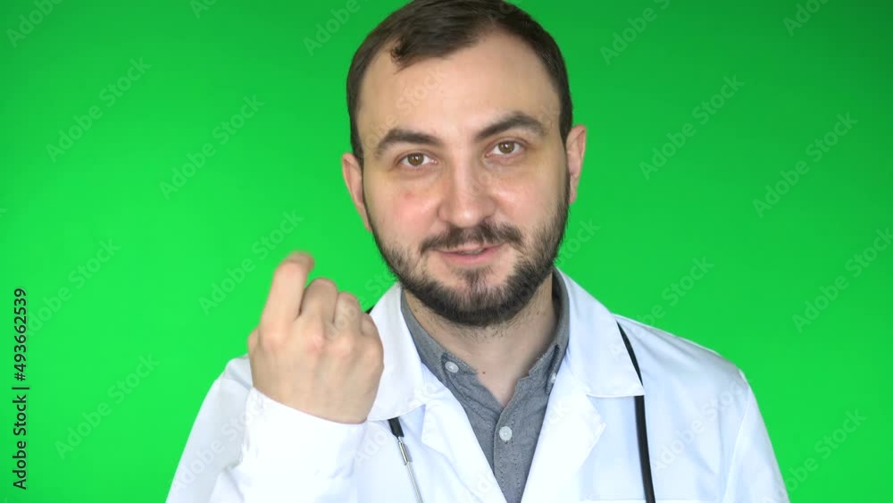 Medical doctor man looking at camera and inviting someone. Green screen background Medical doctor man looking at camera and inviting someone. Green screen background