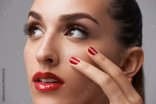 Red is this seasons must-have color. Cropped view of a fashion model showcasing cosmetics trends.