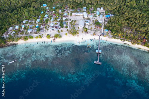 The quaint village of Sawandarek looks out on the Dampier Strait in Raja Ampat, Indonesia. This tropical region is known as the heart of the Coral Triangle due to its high marine biodiversity. photo
