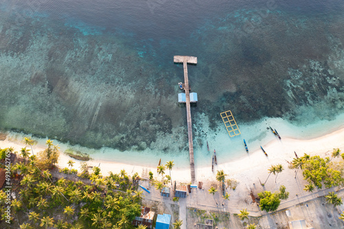 The quaint village of Sawandarek looks out on the Dampier Strait in Raja Ampat, Indonesia. This tropical region is known as the heart of the Coral Triangle due to its high marine biodiversity. photo