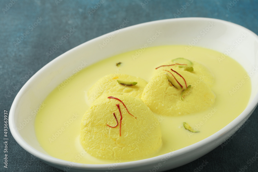 Rasmalai is an Indian dessert sweet with dry fruits and Saffron toppings, served in a bowl . selective focus Rasmalai is an Indian dessert sweet with dry fruits and Saffron toppings, served in a bowl . selective focus