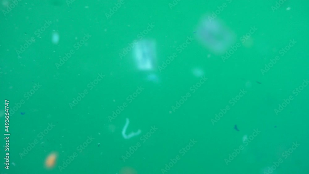 Microplastics in polluted water. Concept of global warming and climate change. Non-recyclable plastic pollution in the oceans. Selective focus of underwater micro plastic.