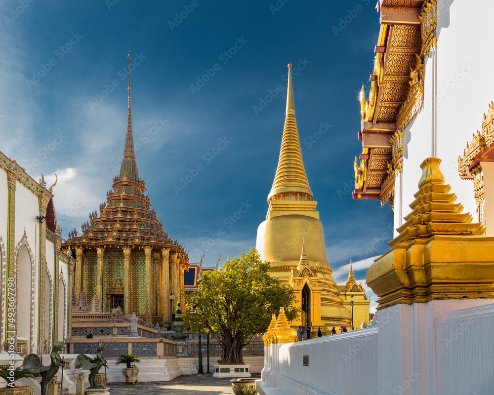 Fototapeta premium Courtyard of ornate Buddhist temples with golden and colorful decorative details, Bangkok, Thailand