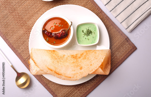 South Indian food Photos. Masala dosa, onion uttapam, sambhar, coconut chutney served in cutlery. photo