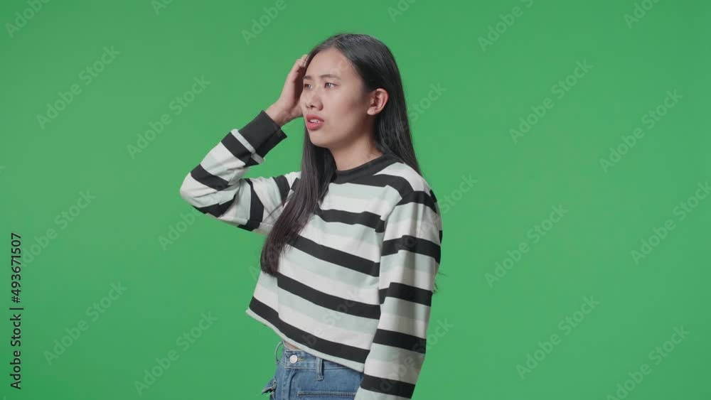 Side View Of A Puzzled Asian Woman Is Standing In Front Of Green Screen Background
Side View Of A Puzzled Asian Woman Is Standing In Front Of Green Screen Background