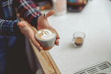 Close up photo of woman hands holding cup of cappuccino