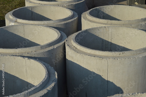large concrete sewer pipes lined up on the ground