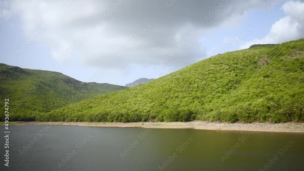 Willingdon Dam filled with water and lush green Girnar mountain on background at Junagadh, Gujarat, India. Beautiful nature during monsoon season. Monsoon landscape. Willingdon Dam filled with water and lush green Girnar mountain on background at Junagadh, Gujarat, India. Beautiful nature during monsoon season. Monsoon landscape.