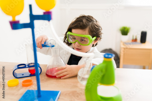 Little boy playing with a chemistry game