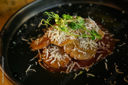 Haute cuisine dish, bulls testicles with tomato, cheese and herbs.
