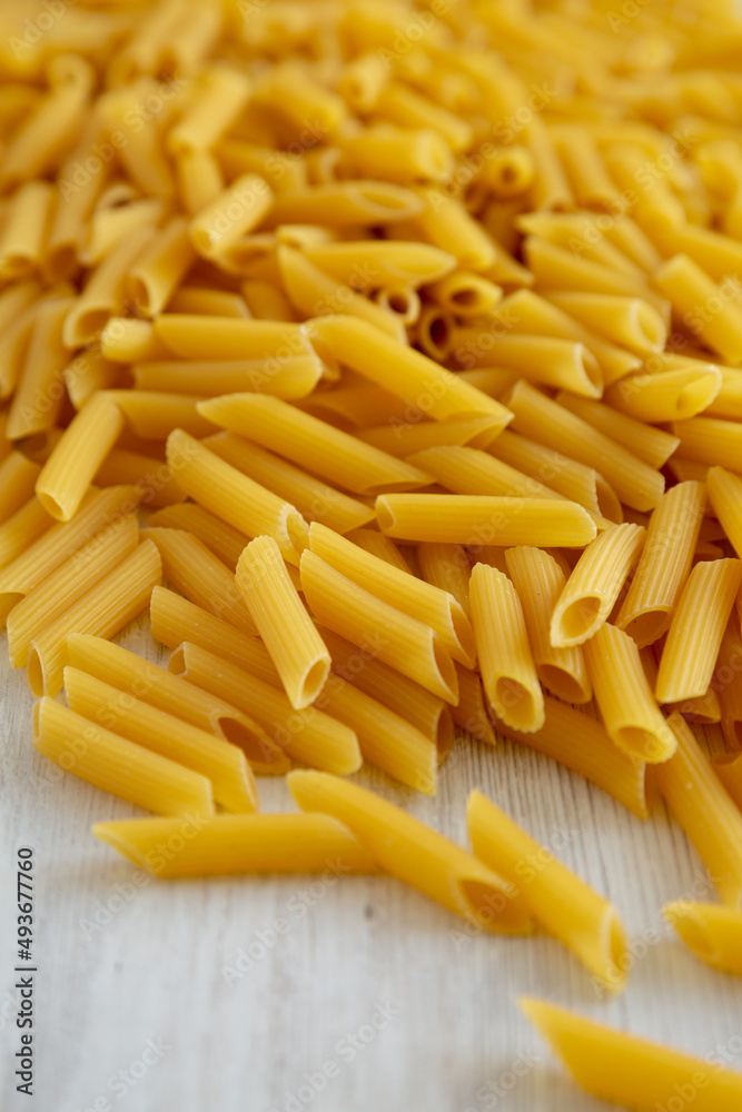 Homemade Raw Dry Penne Pasta, side view. Homemade Raw Dry Penne Pasta, side view.