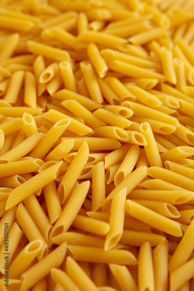 Homemade Raw Dry Penne Pasta, side view. Homemade Raw Dry Penne Pasta, side view.