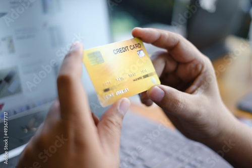 Man holding credit card and use laptop for with shopping online. Online payment concept.