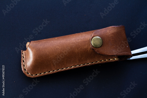 Leather knife sheath with the black background. Leathercraft tools