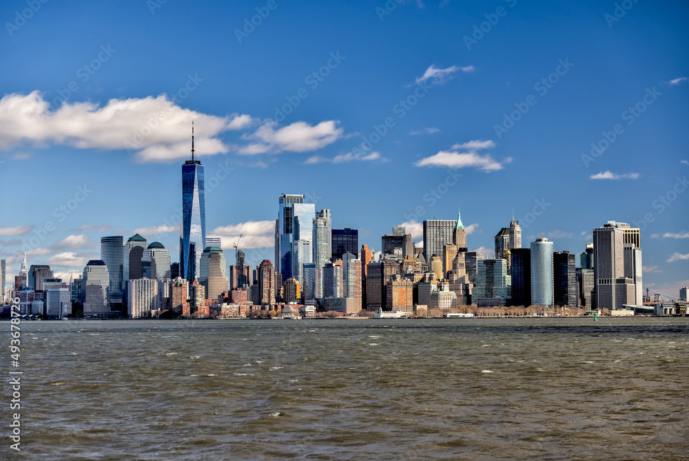 Obraz premium Views of Battery Park and the financial district from the water and Ellis Island in New York City