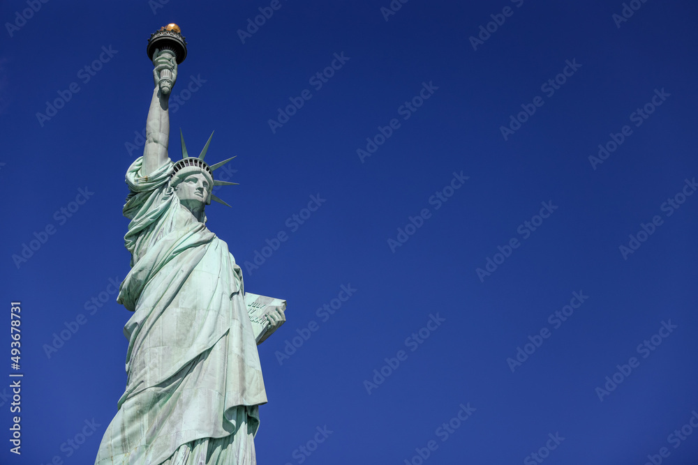 Fototapeta premium The Statue of Liberty in New York against a blue sky