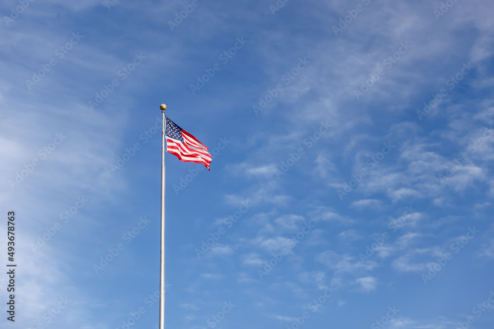 United States flag against a clear blue sky United States flag against a clear blue sky
