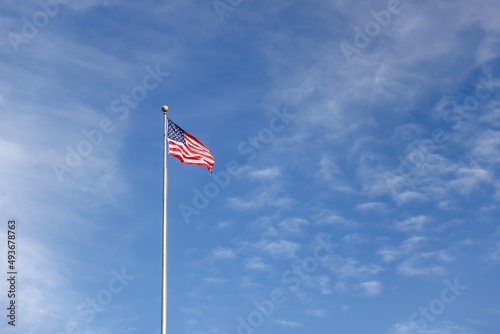 United States flag against a clear blue sky