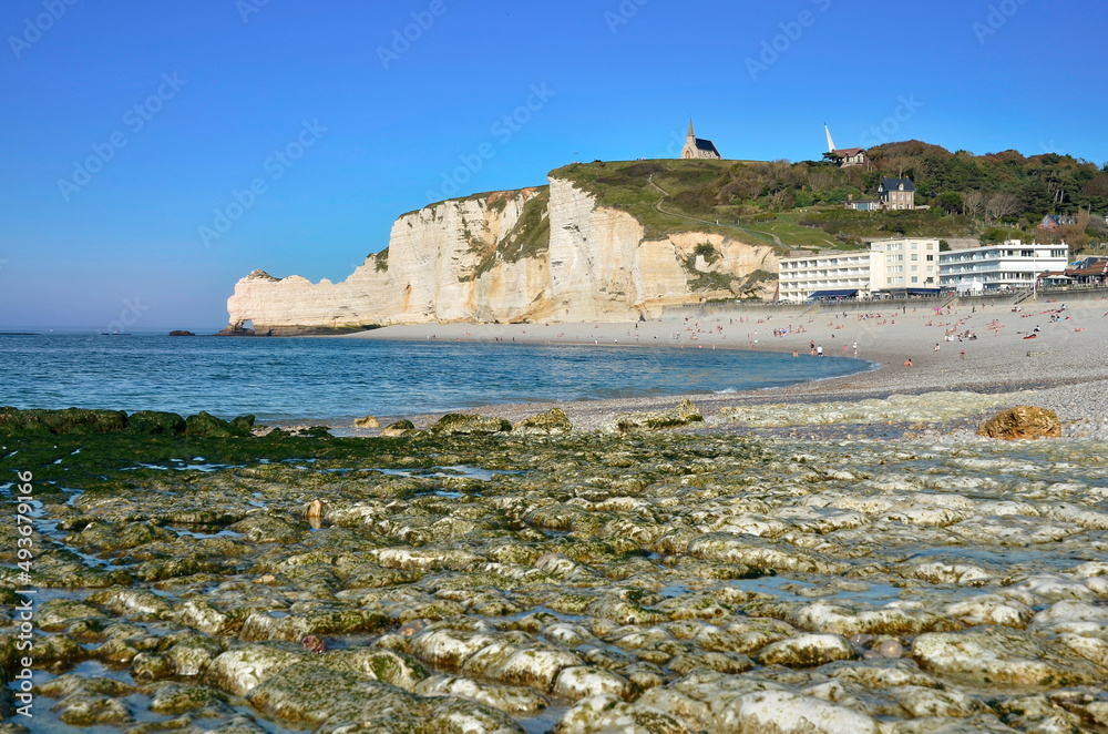 Pebble beach and famous upstream cliffs of Etretat, commune in the Seine-Maritime department in the Haute-Normandie region in northwestern France