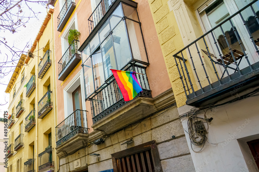 Facade of the Chueca neighborhood in the city of Madrid with a rainbow flag representing homosexual pride and the defense of LGTBI rights