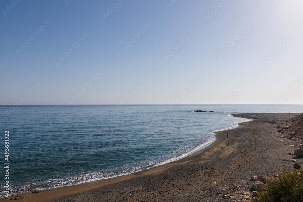 Summer landscape of Crete island in Greece in Europe. Coast in the Larapetra region. In the background is a sunny sky with clouds.