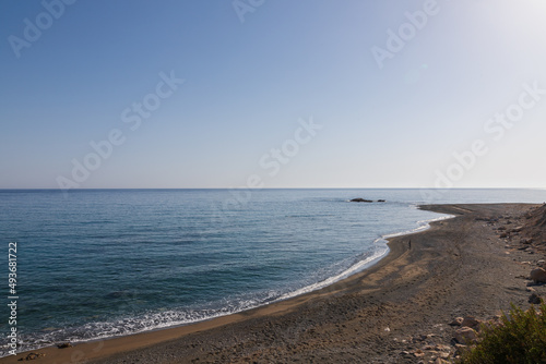 Summer landscape of Crete island in Greece in Europe. Coast in the Larapetra region. In the background is a sunny sky with clouds.