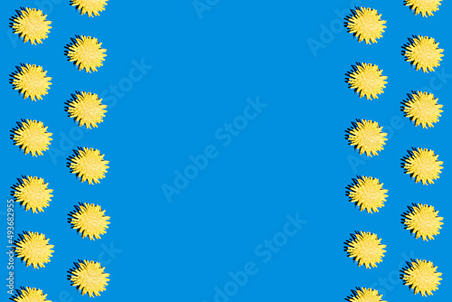 Trendy hard shadow sun light yellow dandelion or chamomile daisy flower on a bright blue background. Isometric hot summer or fall seamless pattern wallpaper design. Funky 90's nostalgia concept.
