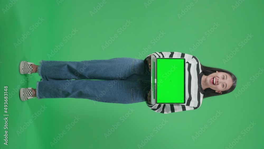 Full Body Of A Smiling Asian Woman Saying Wow While Holding Green Screen Computer In The Green Screen Studio
Full Body Of A Smiling Asian Woman Saying Wow While Holding Green Screen Computer In The Green Screen Studio
