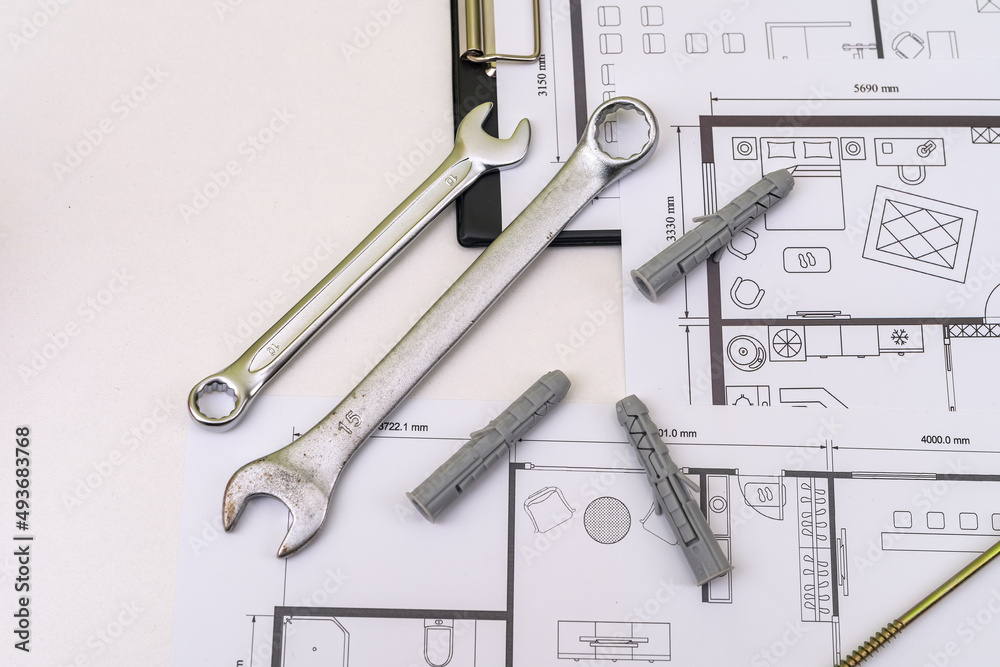 Fototapeta premium house blueprints with work tools drawing instruments on the worktable