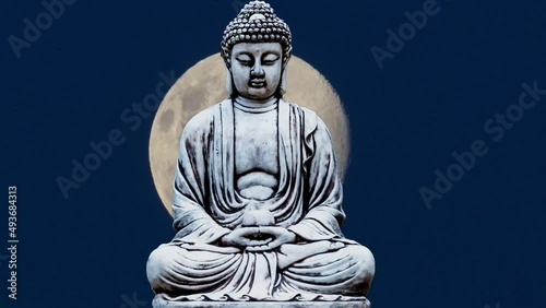 Buddha statue sitting in meditation and background with full moon.