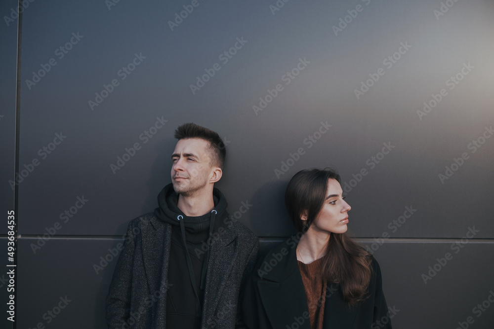 Young loving couple with coffee on black industrial background Young loving couple with coffee on black industrial background