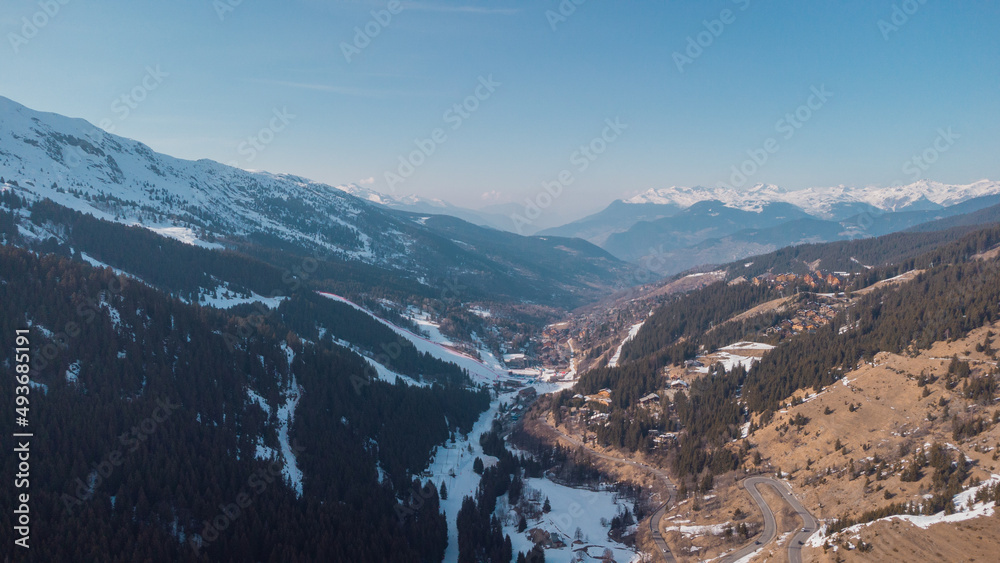Aerial panorama of Meribel village, on the end of the valley in the french Alps. Beautiful panorama of ski slopes and chalets with alpine background.